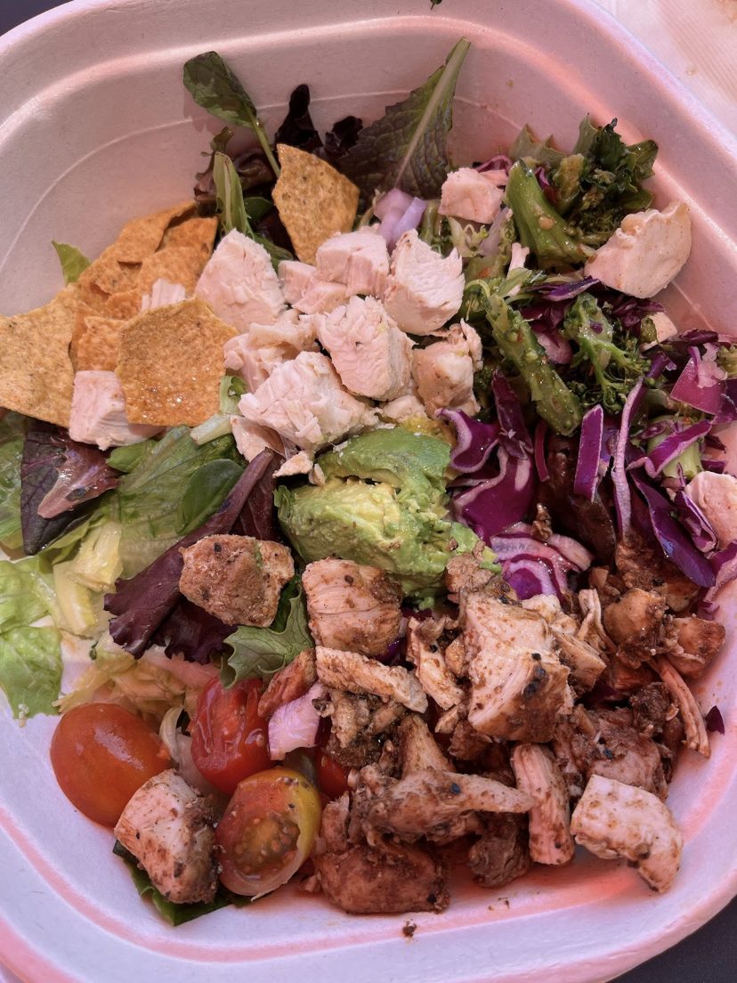 Chicken salad bowl with avocado, red cabbage, and tomatoes